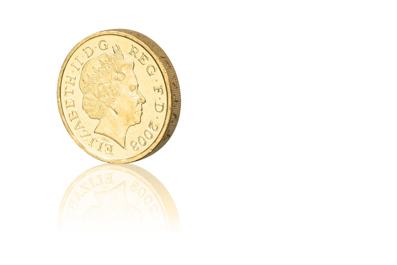 Immagine di una sterlina d'oro con dettagli su valore e collezionismo.